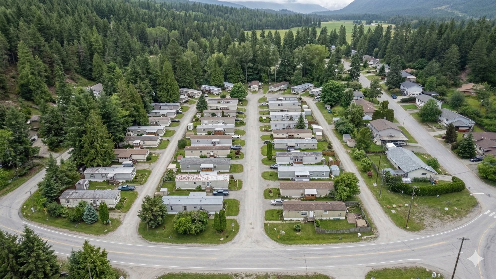 Aerial view of a mobile home park in British Columbia, rows of homes set in forest